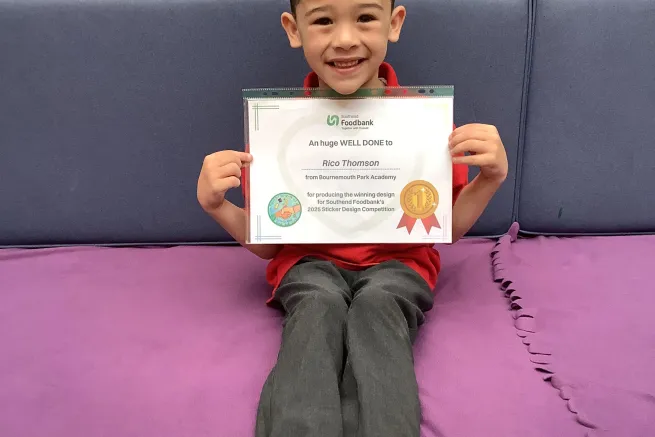 Rico smiles with his winner's certificate.