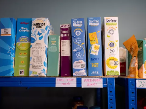 A shelf at a food bank filled with Free From cereal boxes.